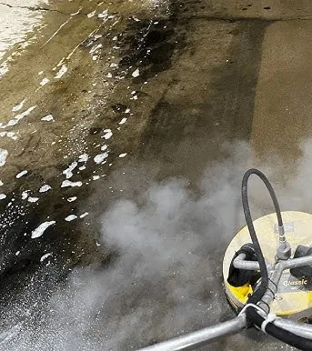 Before hot water pressure washing — stained concrete walkway in Proctor, MN
