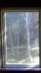 Before window cleaning in Proctor, MN — filmy residential glass with hard-water spotting | Up North Pressure Washing